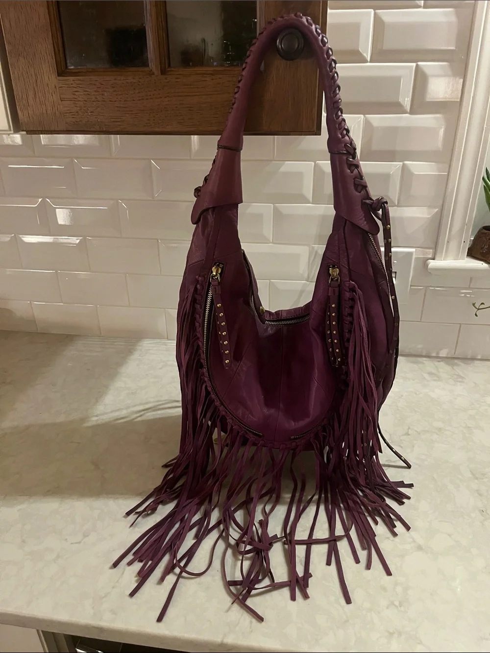 orYANY purple Studded  fringed Leather Hobo Bag with geometric interior material